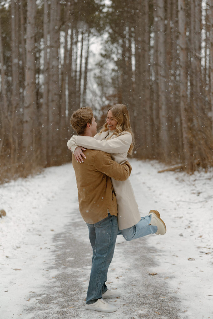 Couple taking engagement photos in the winter