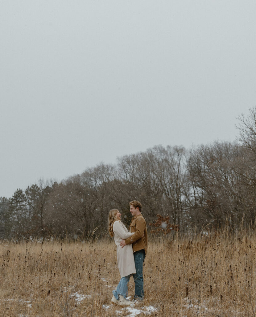 Couple taking engagement photos in the winter