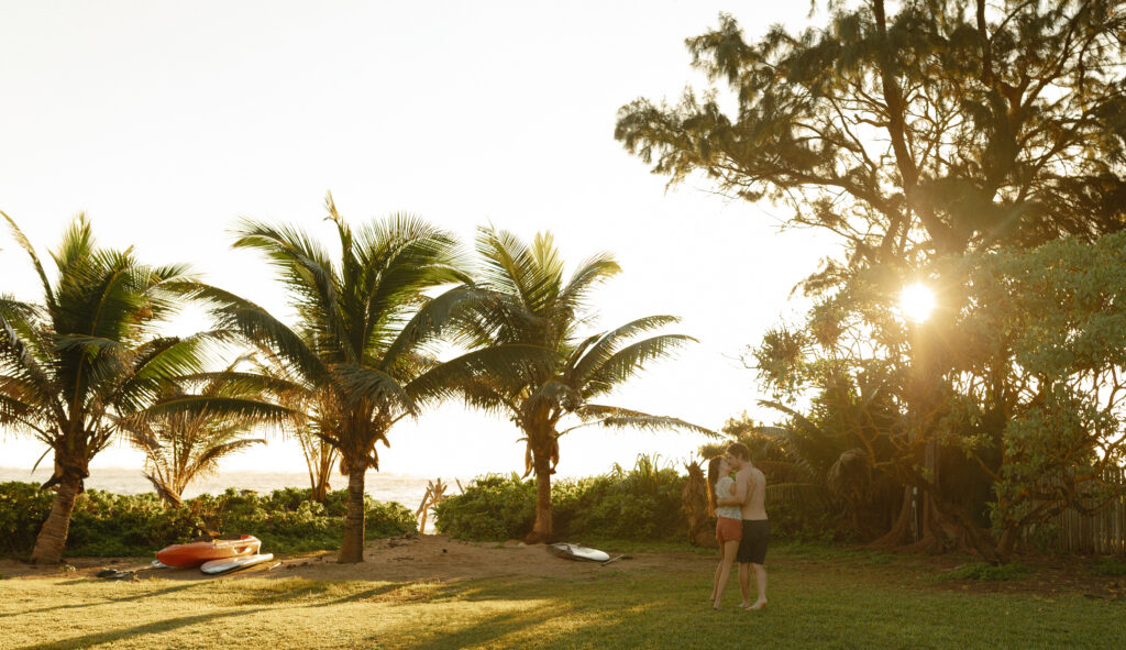 Married couple on a private beach in Oahu, Hawaii at sunrise