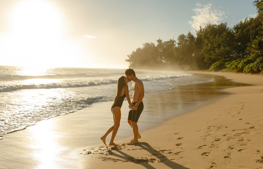 Married couple on a private beach in Oahu, Hawaii at sunrise