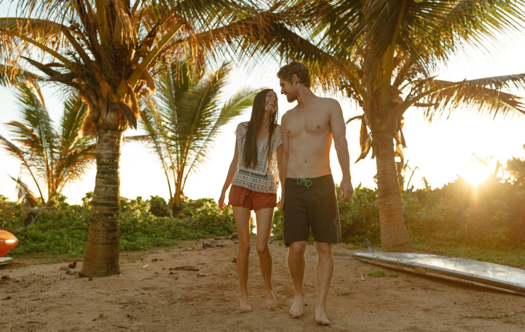 Married couple on a private beach in Oahu, Hawaii at sunrise