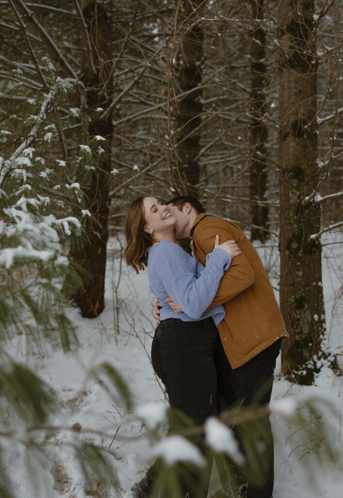 Couple taking engagement winter photos in Minnesota