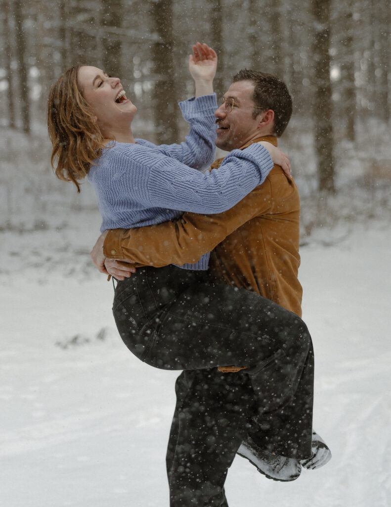 Couple taking engagement winter photos in Minnesota