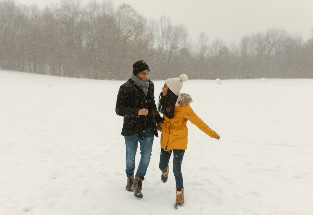 Couple taking engagement photos in the winter