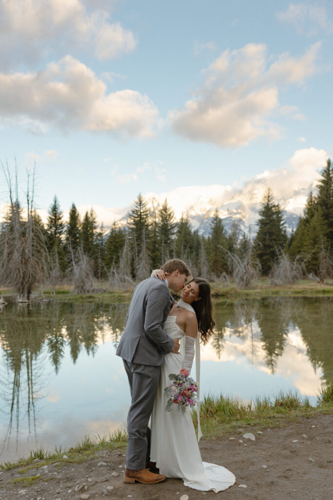 A couple eloping at sunrise at Schwabacher Landing in Grand Teton National Park