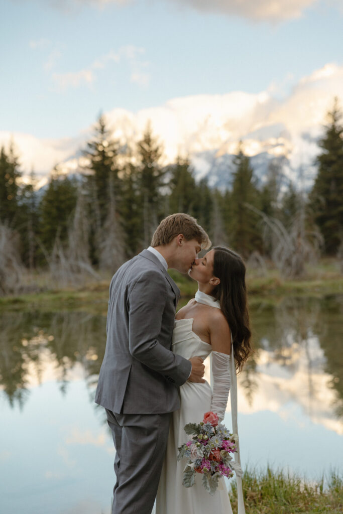 A couple eloping at sunrise at Schwabacher Landing in Grand Teton National Park