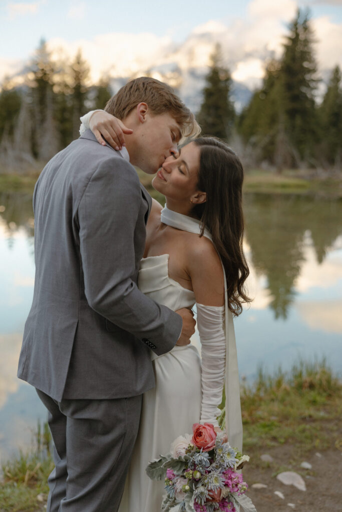 A couple eloping at sunrise at Schwabacher Landing in Grand Teton National Park