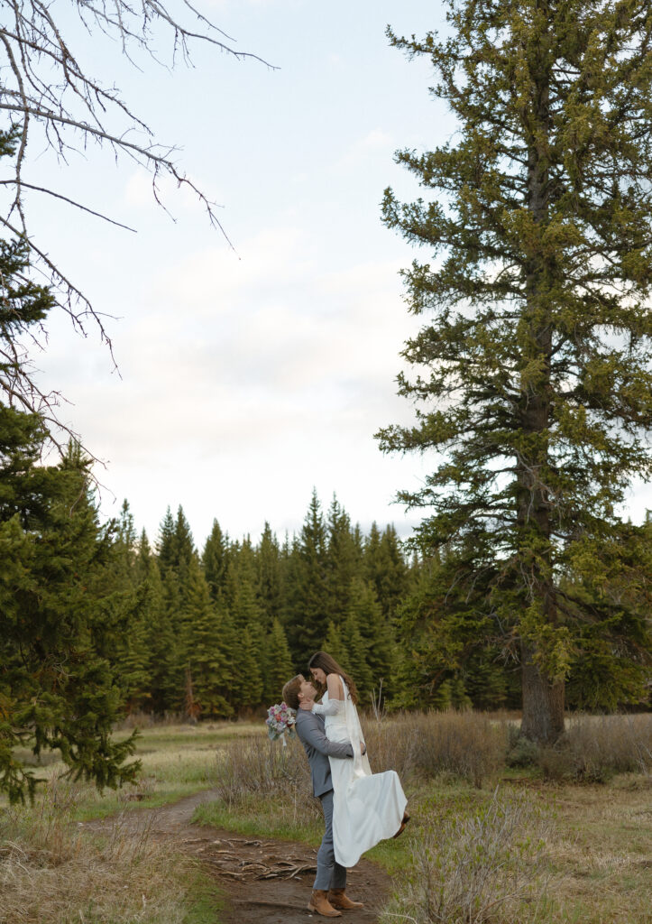 A couple eloping at sunrise at Schwabacher Landing in Grand Teton National Park