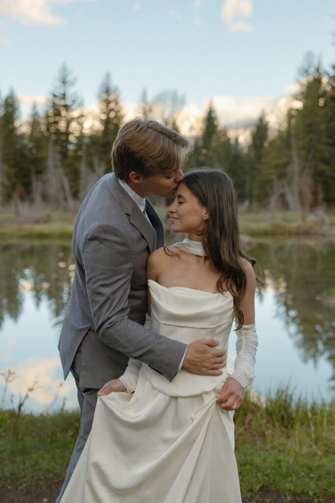 A couple eloping at sunrise at Schwabacher Landing in Grand Teton National Park