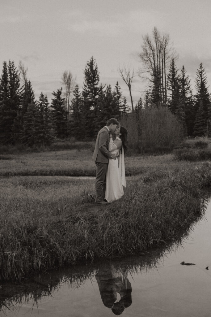 A couple eloping at sunrise at Schwabacher Landing in Grand Teton National Park