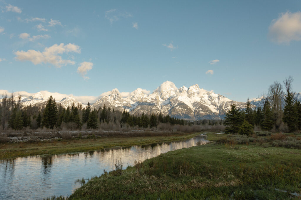A couple eloping at sunrise at Schwabacher Landing in Grand Teton National Park