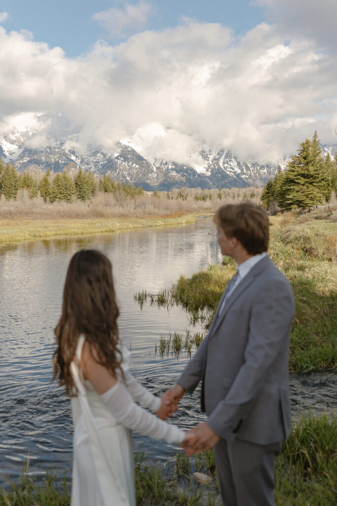 A couple eloping at sunrise at Schwabacher Landing in Grand Teton National Park