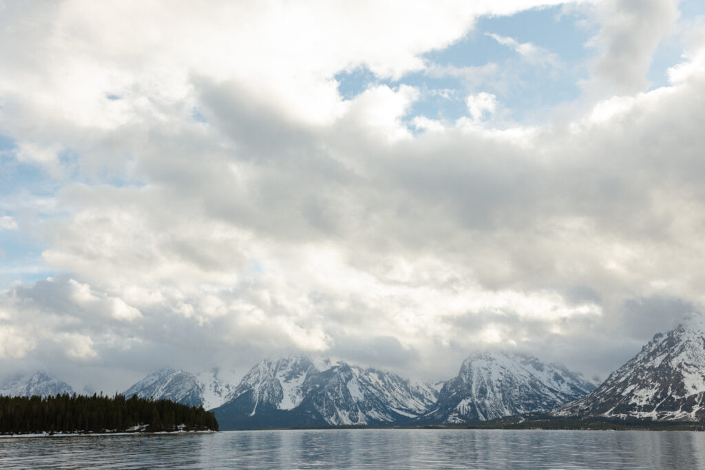 Bride and groom embracing during a moody Colter Bay elopement in Grand Teton National Park