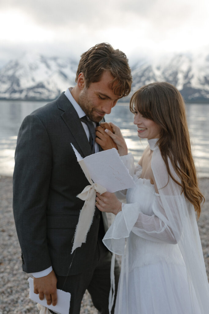 Bride and groom embracing during a moody Colter Bay elopement in Grand Teton National Park