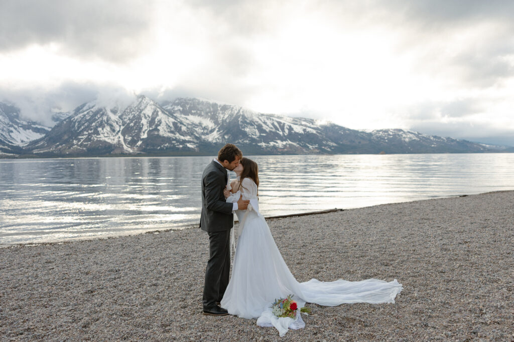 Bride and groom embracing during a moody Colter Bay elopement in Grand Teton National Park