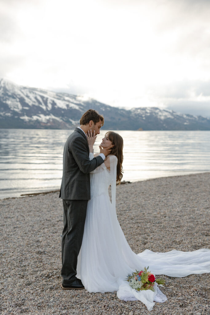 Bride and groom embracing during a moody Colter Bay elopement in Grand Teton National Park