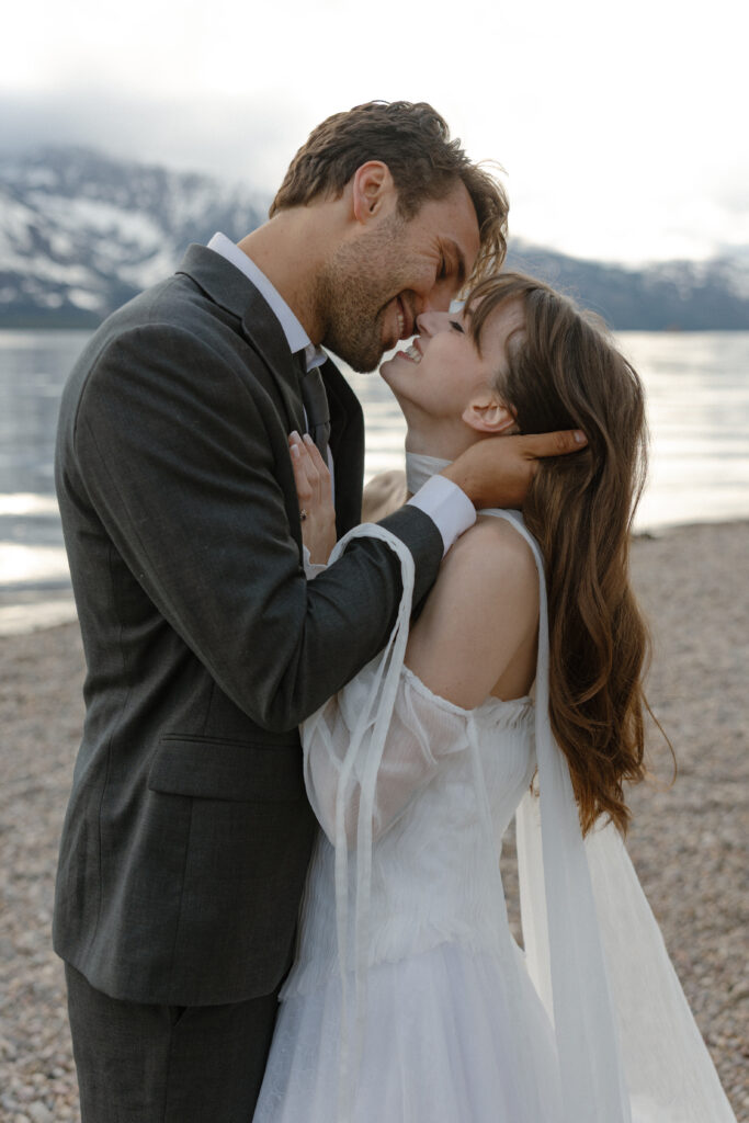 Bride and groom embracing during a moody Colter Bay elopement in Grand Teton National Park