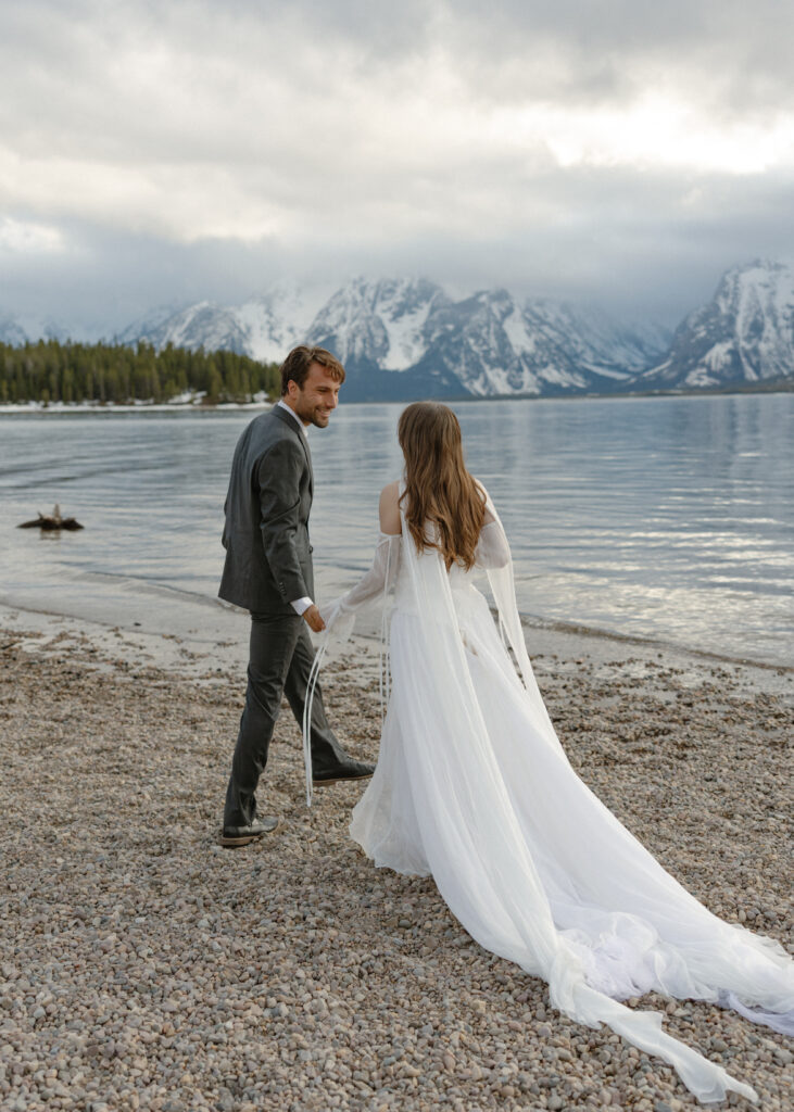 Bride and groom embracing during a moody Colter Bay elopement in Grand Teton National Park