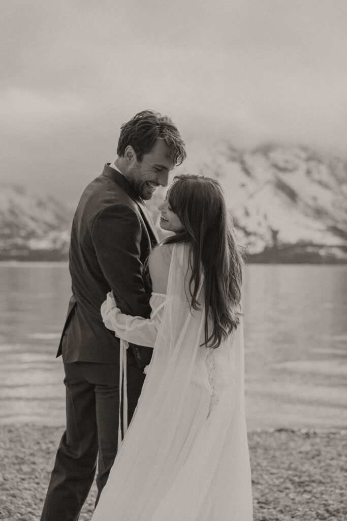 Bride and groom embracing during a moody Colter Bay elopement in Grand Teton National Park