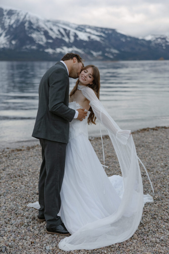 Bride and groom embracing during a moody Colter Bay elopement in Grand Teton National Park