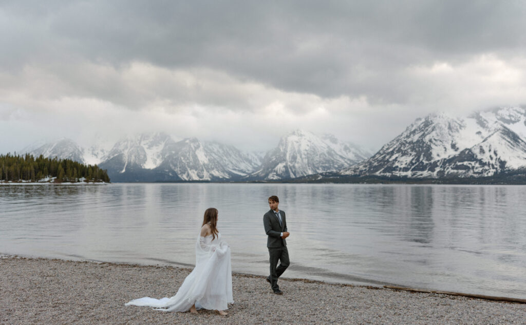 Bride and groom embracing during a moody Colter Bay elopement in Grand Teton National Park