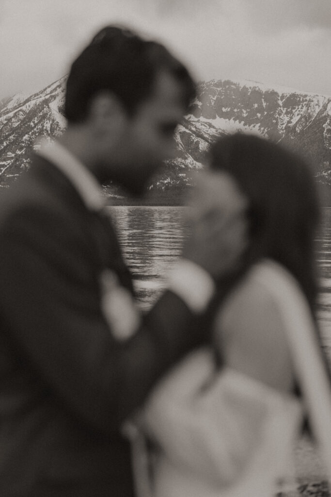 Bride and groom embracing during a moody Colter Bay elopement in Grand Teton National Park