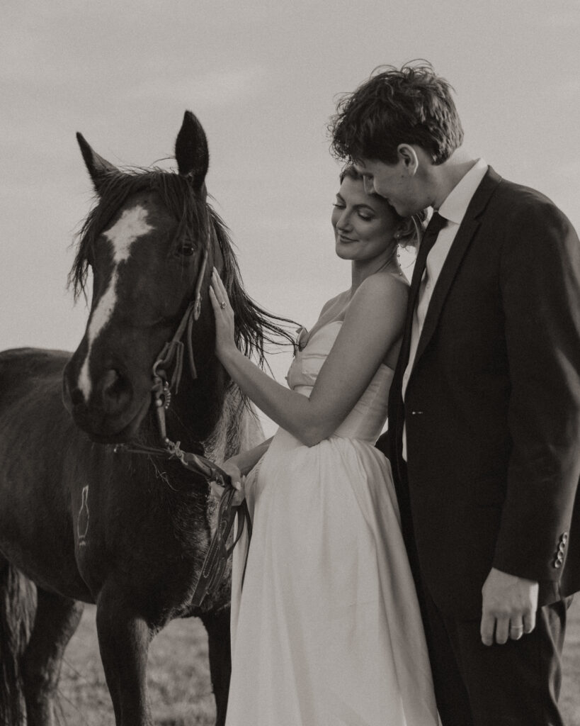 Bride and groom walking through open pasture during a luxurious Wyoming horse elopement at Heiner Ranch near Jackson Hole
