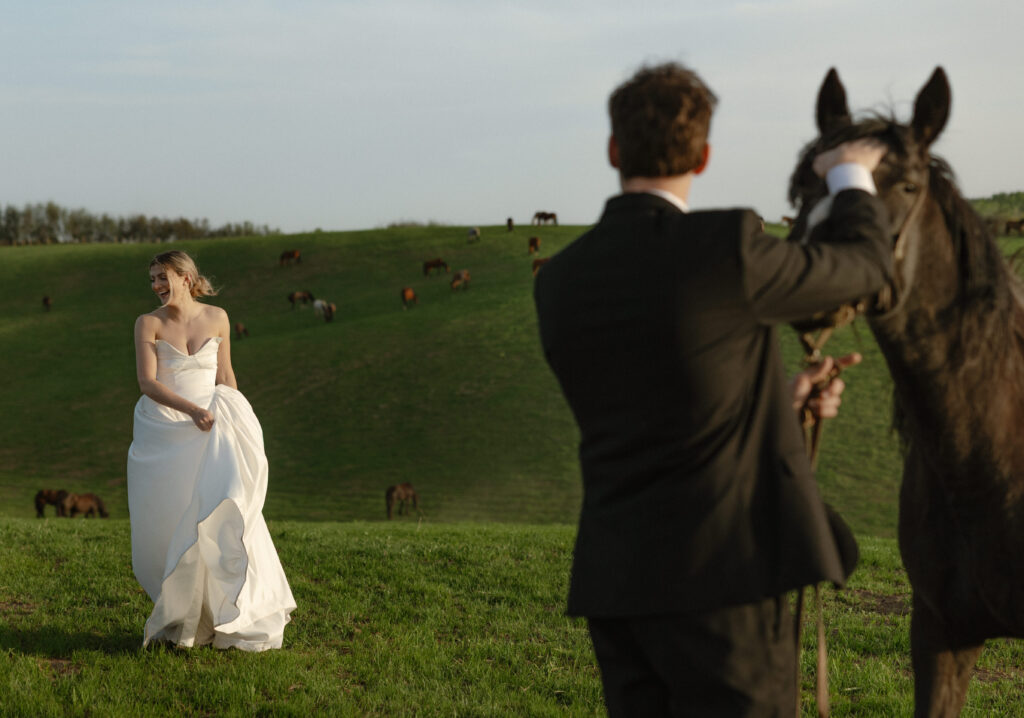 Bride and groom walking through open pasture during a luxurious Wyoming horse elopement at Heiner Ranch near Jackson Hole