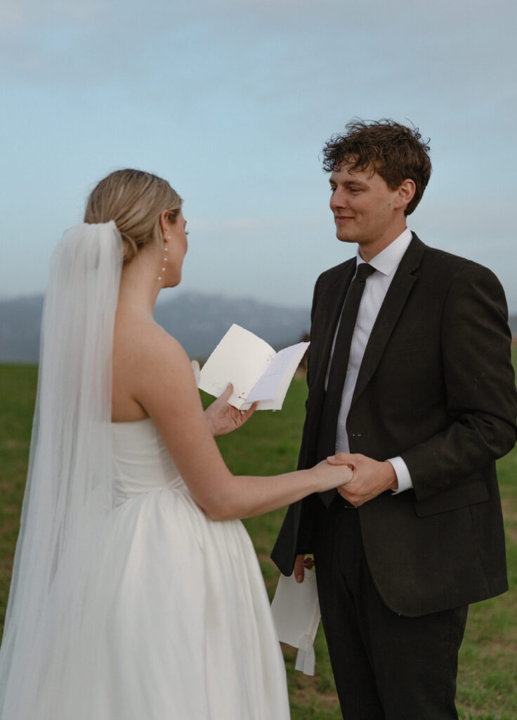 Bride and groom walking through open pasture during a luxurious Wyoming horse elopement at Heiner Ranch near Jackson Hole