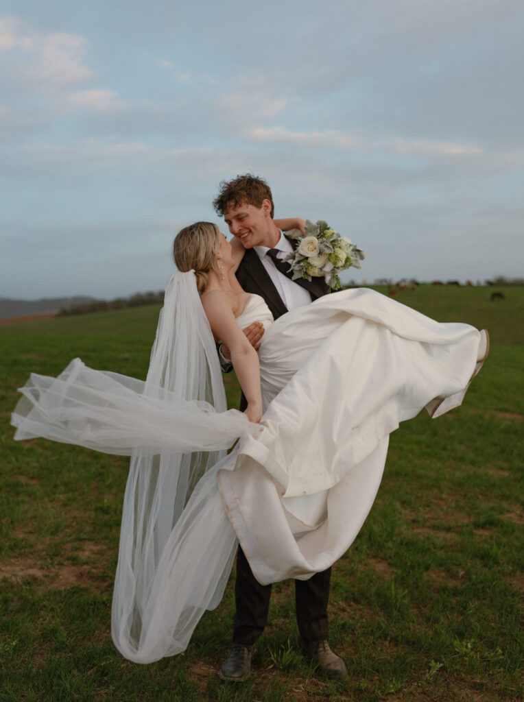 Bride and groom walking through open pasture during a luxurious Wyoming horse elopement at Heiner Ranch near Jackson Hole