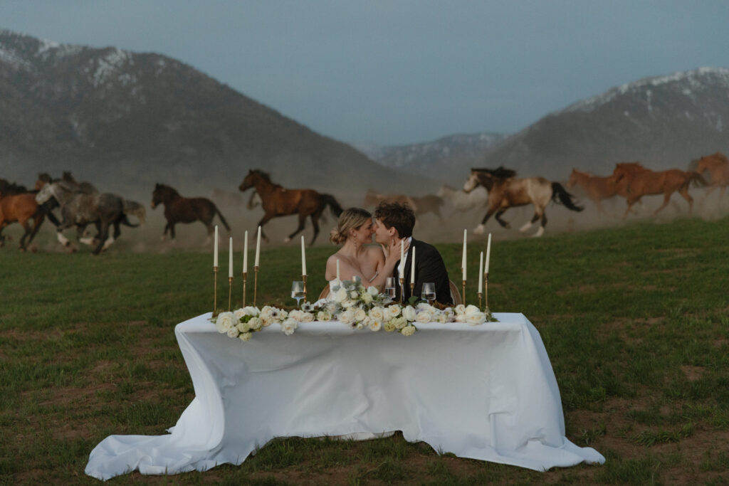 Bride and groom walking through open pasture during a luxurious Wyoming horse elopement at Heiner Ranch near Jackson Hole