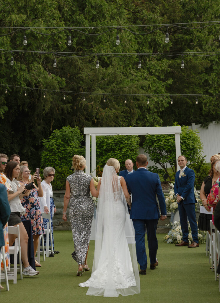 Newlyweds walking down the aisle at their Hutton House wedding