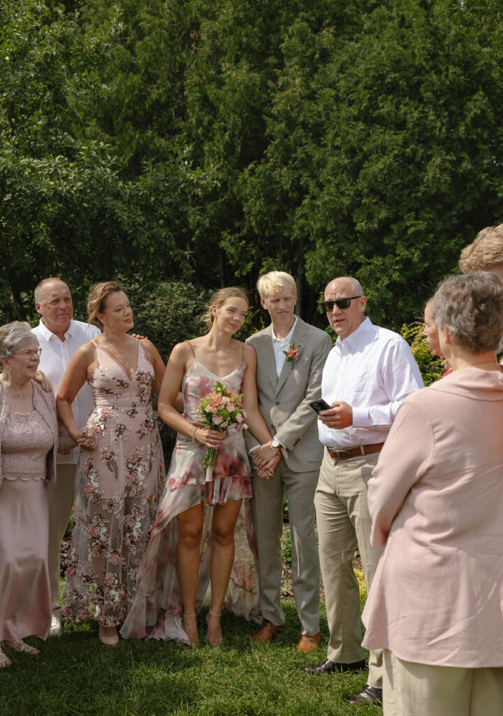 Bride and groom exchanging vows at their intimate Lyndale Rose Garden elopement