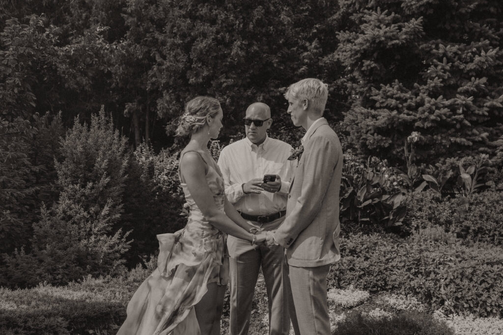 Bride and groom exchanging vows at their intimate Lyndale Rose Garden elopement