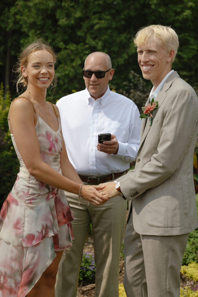Bride and groom exchanging vows at their intimate Lyndale Rose Garden elopement