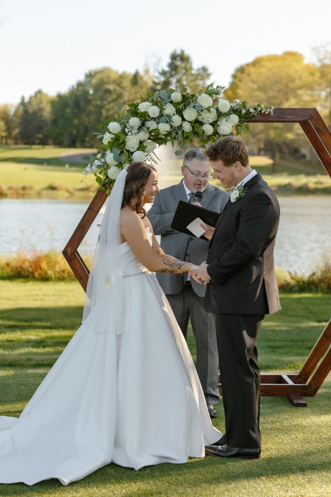 Outdoor waterfront ceremony at Oak Glen Golf Course wedding Stillwater MN