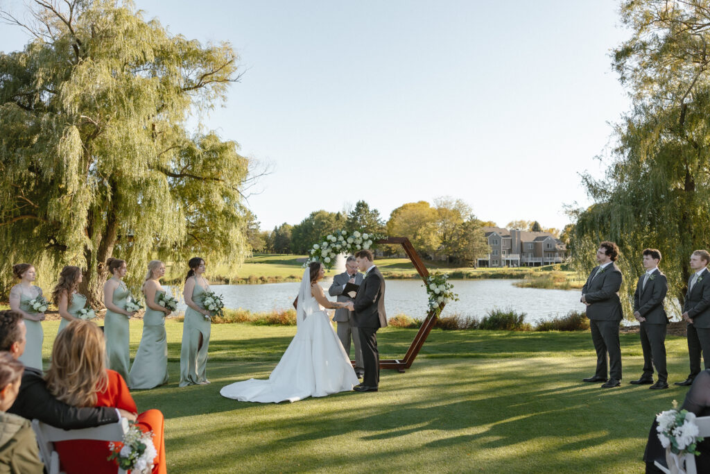 Outdoor waterfront ceremony at Oak Glen Golf Course wedding Stillwater MN
