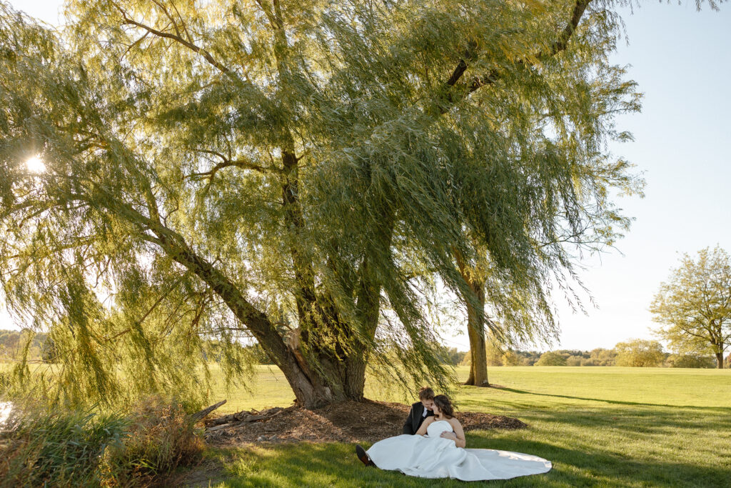 Bride and groom portraits under willow tree at Oak Glen wedding venue