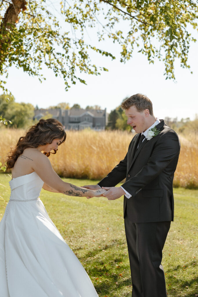 Emotional first look at Oak Glen Golf Course wedding in Stillwater MN