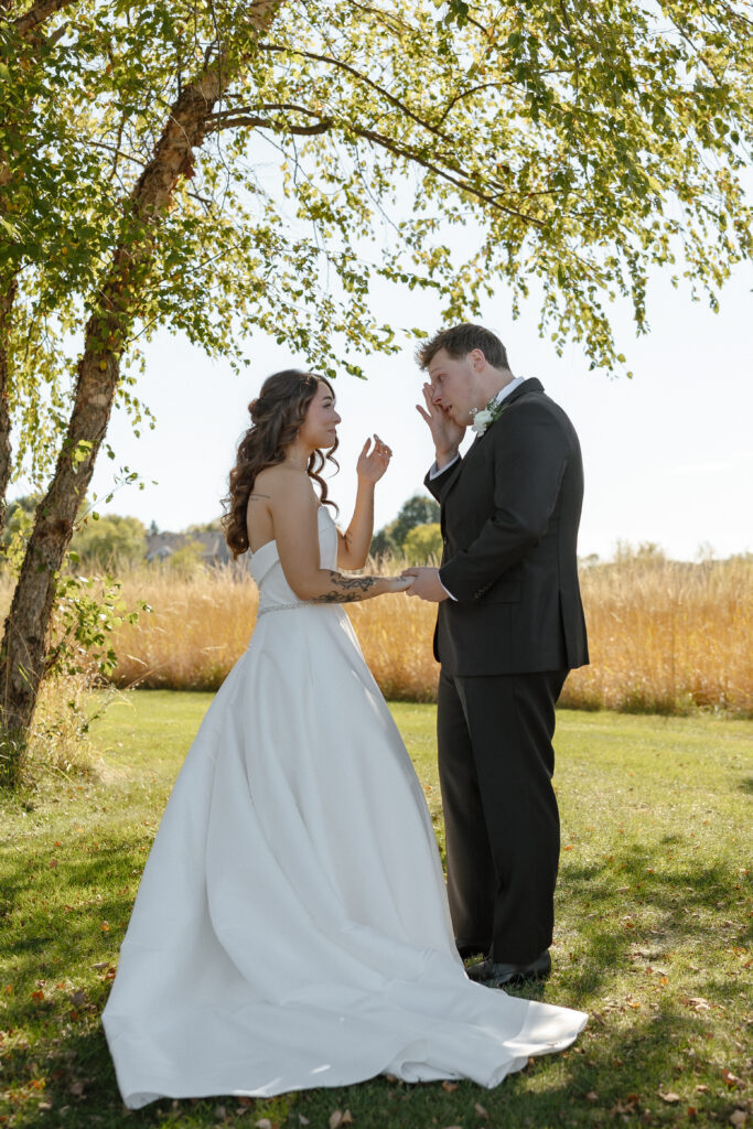 Emotional first look at Oak Glen Golf Course wedding in Stillwater MN
