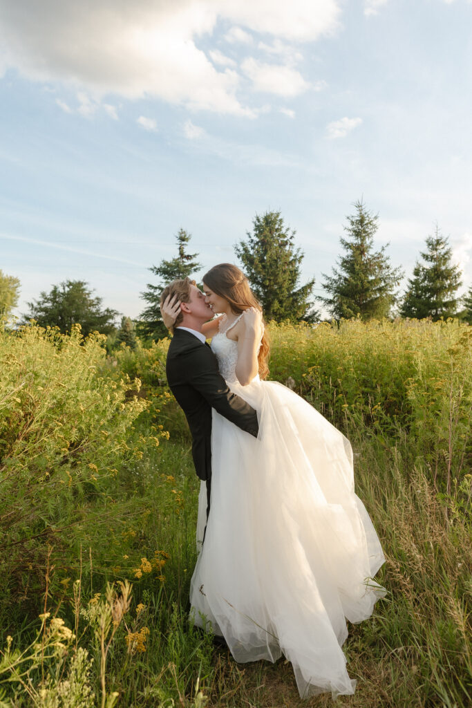Married couple celebrating their romantic summer wedding at Redeemed Farm